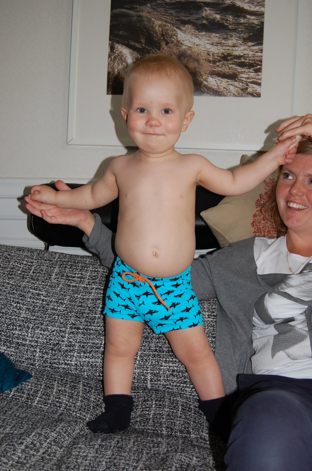 Trying out his bathing trunks for the first time, with the diaper inside...